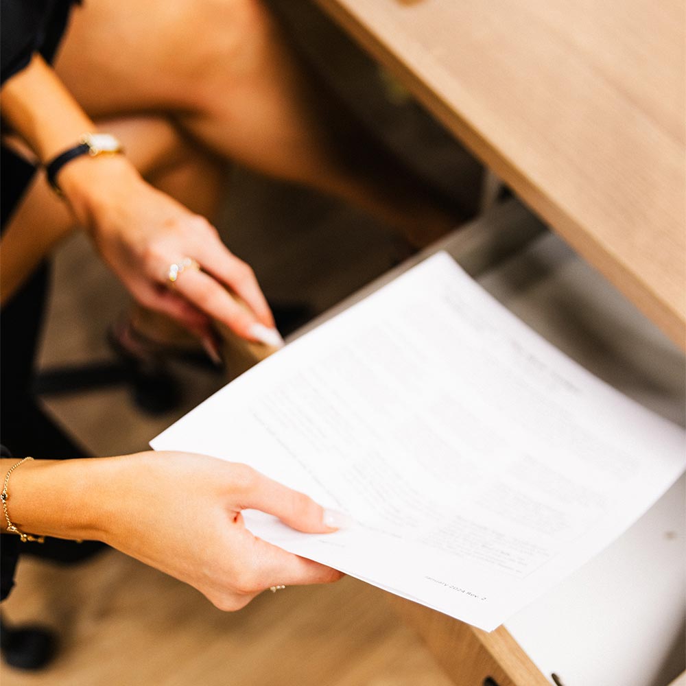 Woman puts a piece of paper on a desk