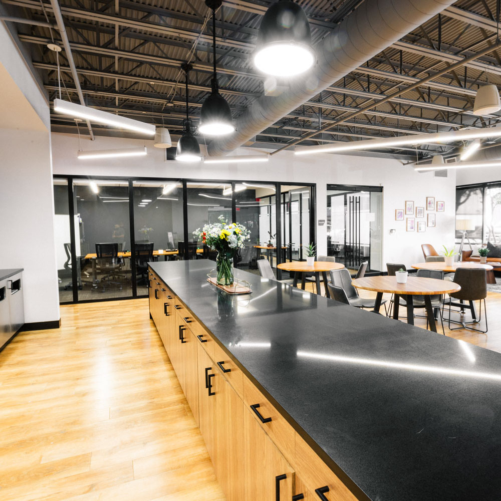 Project Cowork common area with a kitchen, cafe seating, and other seating