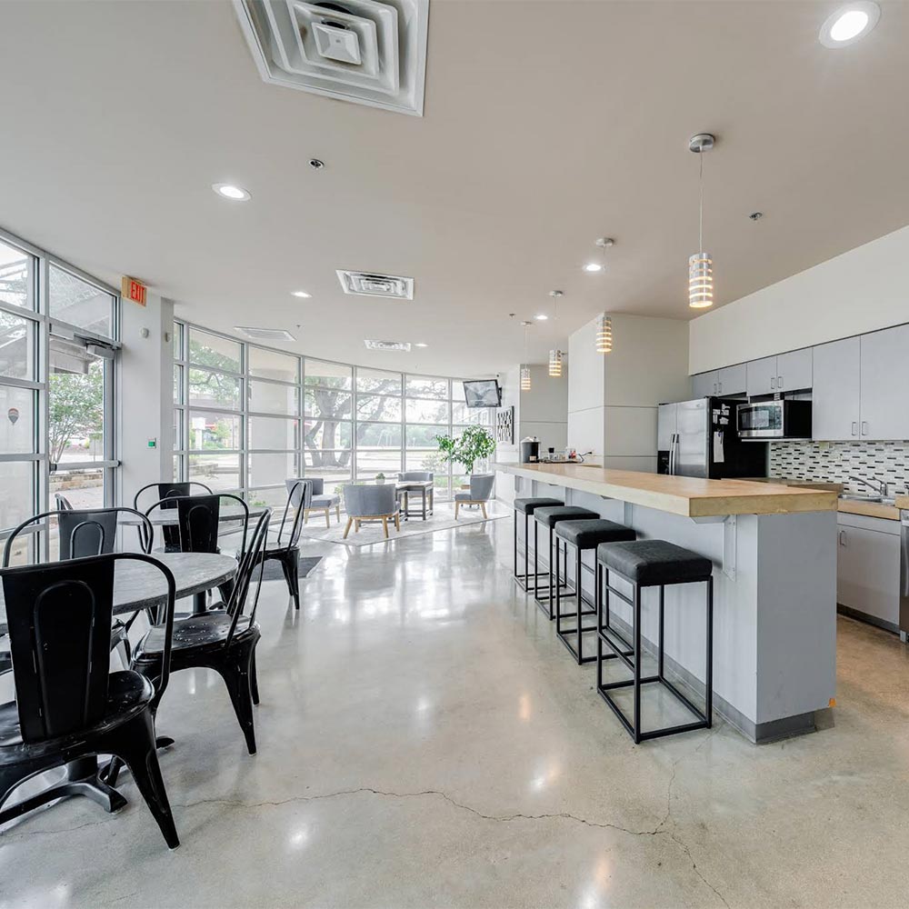 Project Cowork common area with cafe seating and a kitchen