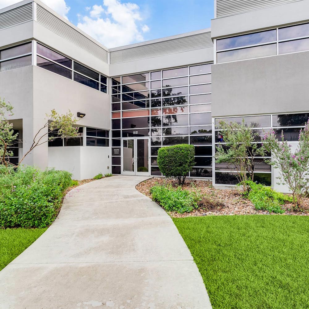 Project Cowork Northwest exterior. There is a blue sky in the background and trees/foliage in the foreground